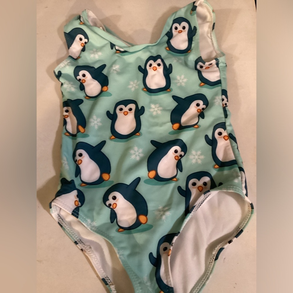 Little girl, penguin swimsuit. 9